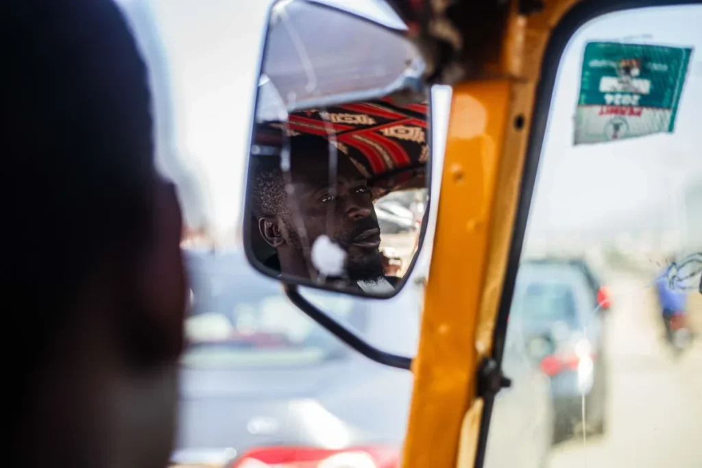 Driver reflected in the side mirror of a truck cab