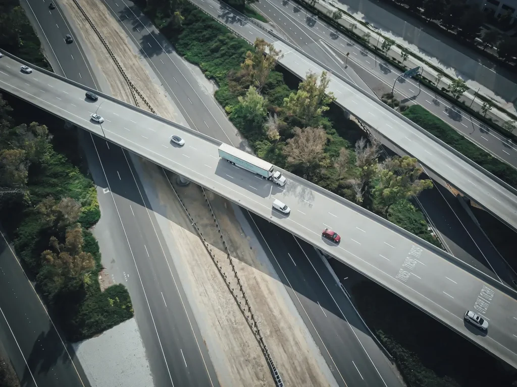 Haulage truck crossing a highway interchange, seen from above