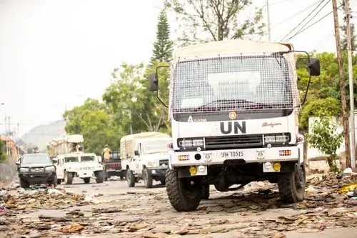 UN Land Cruisers and trucks in convoy on a road