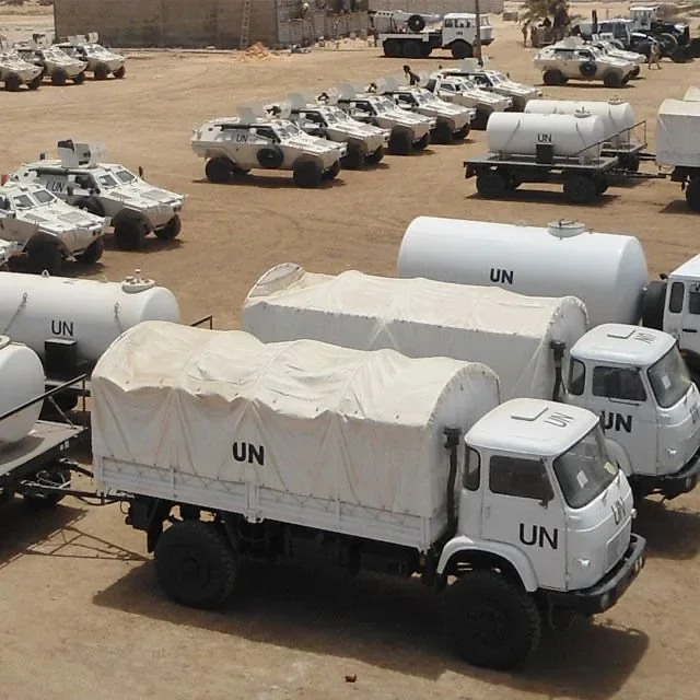 UN trucks and tankers parked in a compound